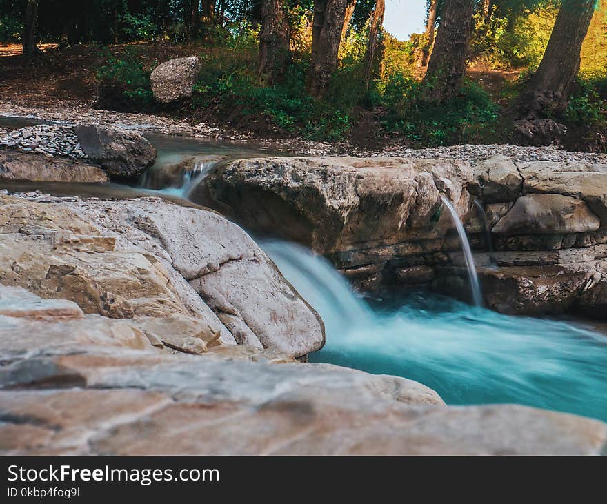 Photography of Water Flow Near Rocks