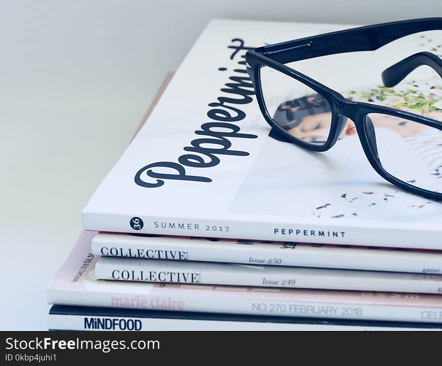 Photo of Eyeglasses On Top of Magazines