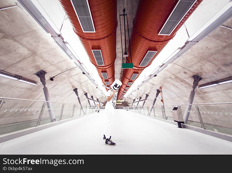 Man Wearing White Shirt and Pants on Tunnel