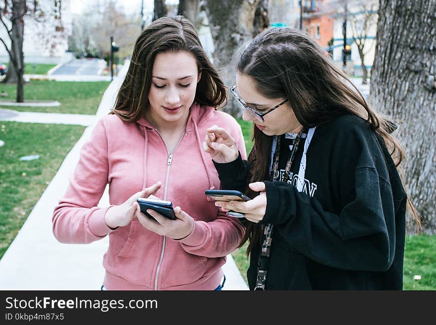 Photography of Women Using Mobile Phones