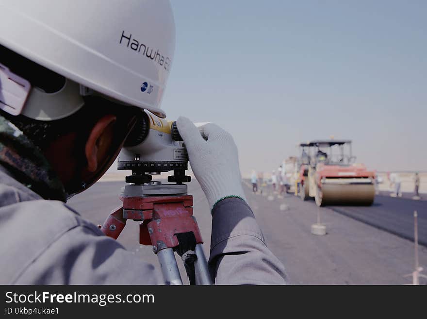 Man Wearing White Gloves Using Telescope