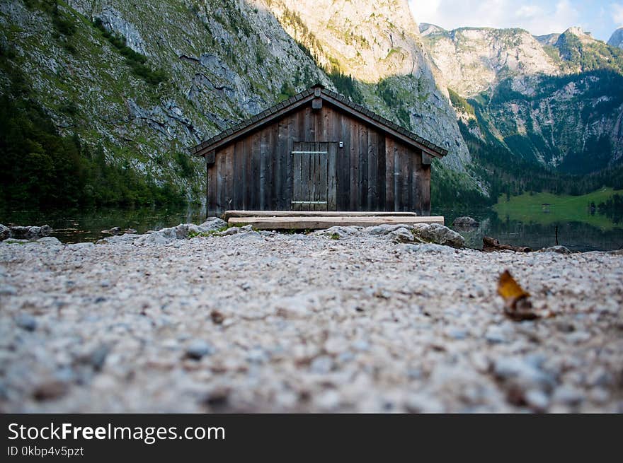 Brown Wooden House Near Green Mountains