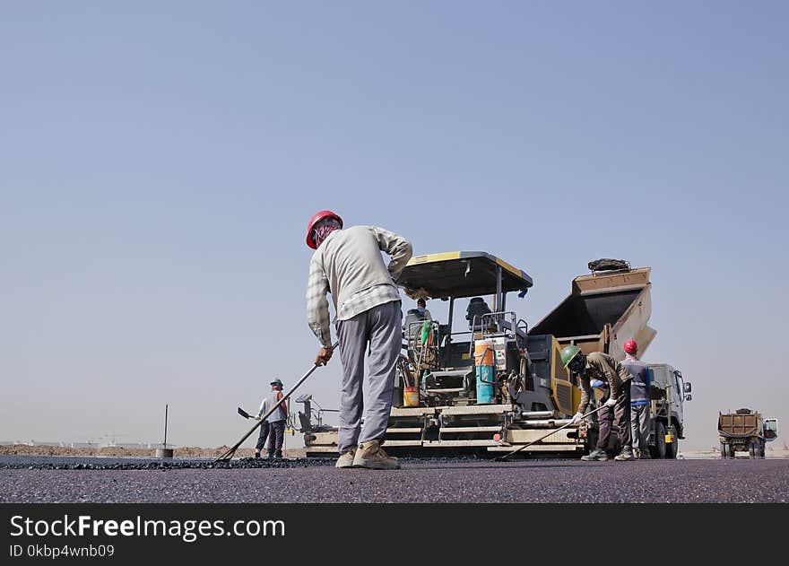 Group of Men Repairing a Road