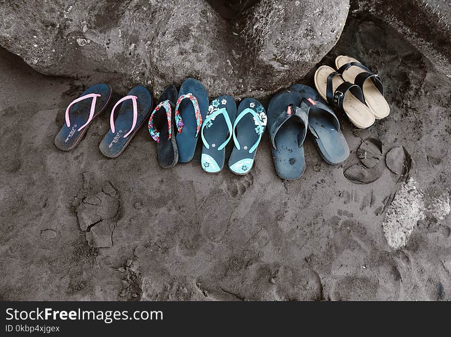 Assorted Flip-flops on Sand