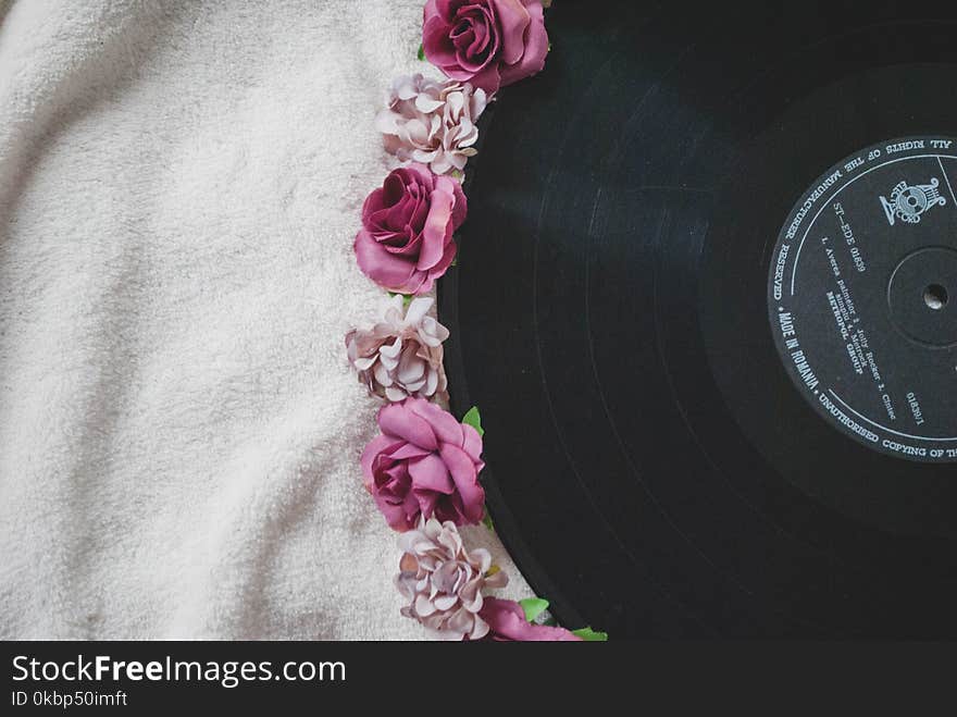 Black Vinyl Disc on White Textile