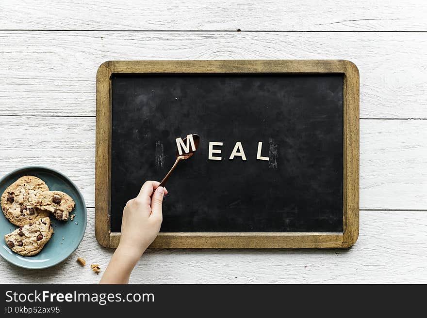 Person Holding Black and Brown Food Tray