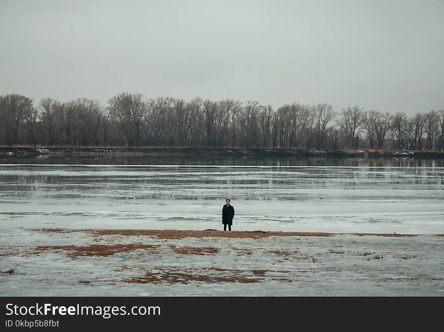 Person Standing Near Body of Water