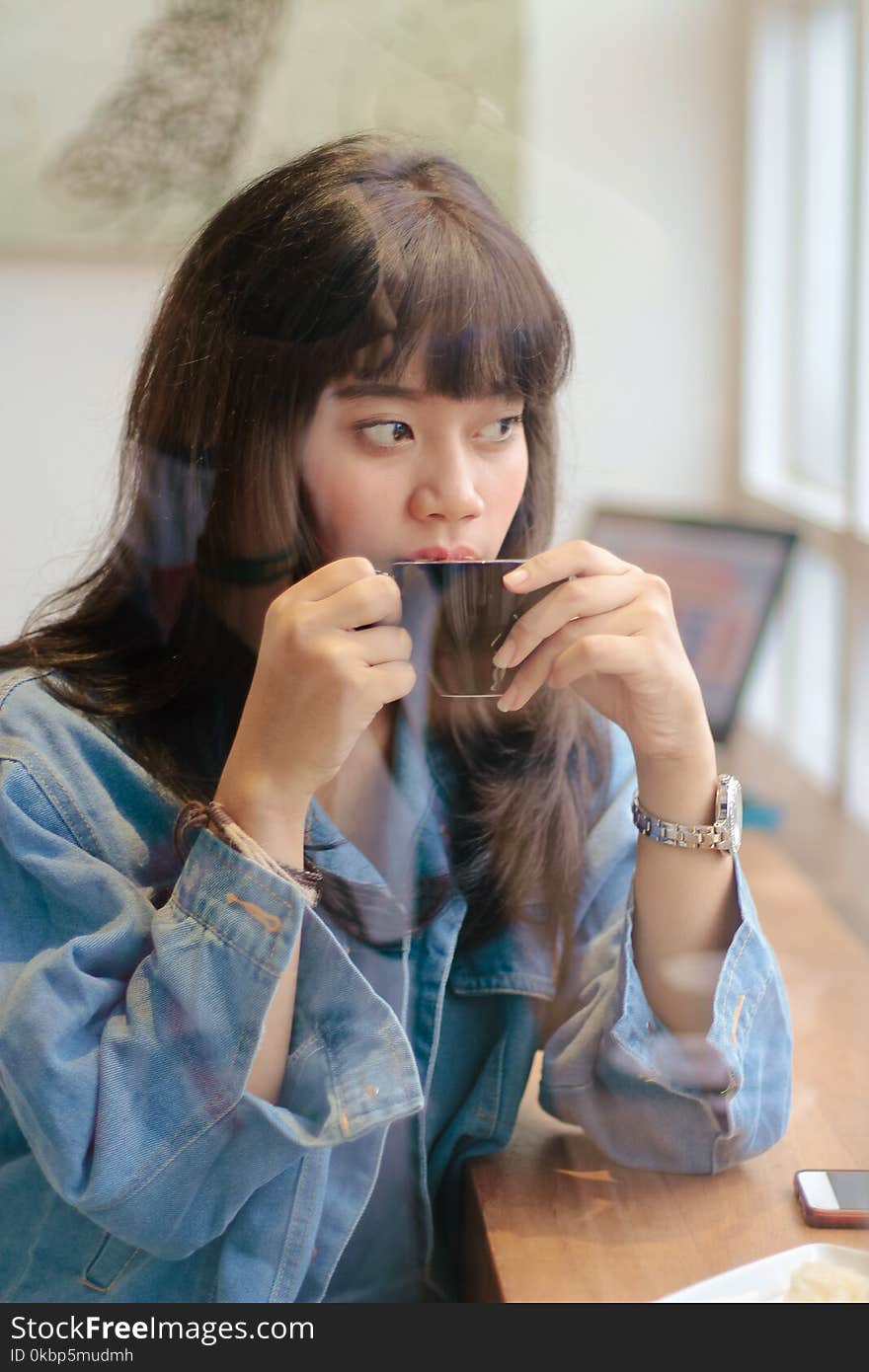 Woman Sipping Coffee