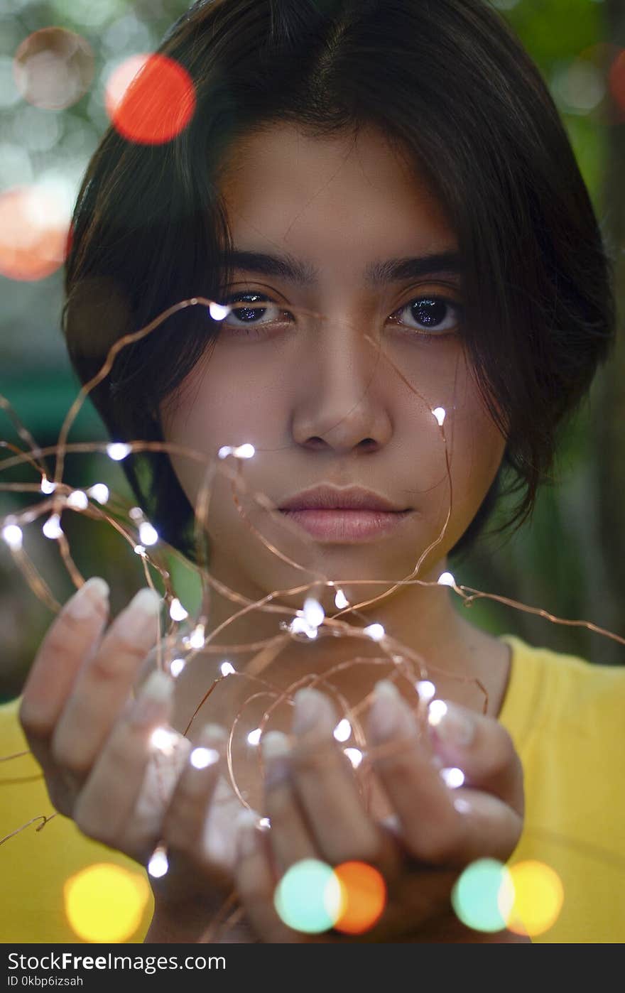 Girl Holding String Lights