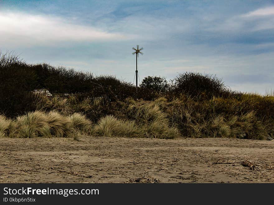 Windmill Surrounded By Grass