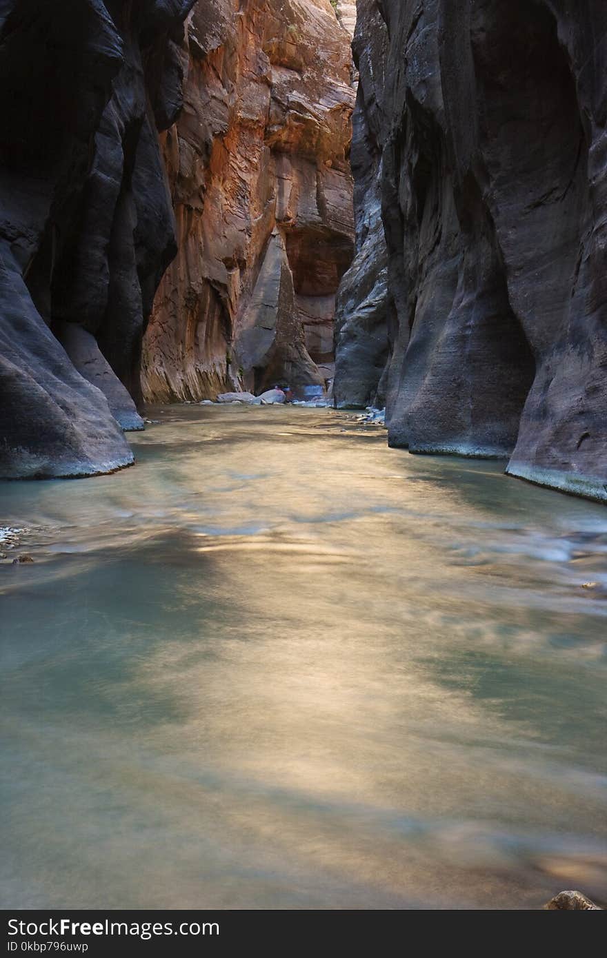 Photo of Body of Water Surrounded by Rock Formation