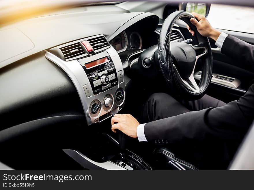 Portrait of a young handsome businessman driving a luxury sports car rich.