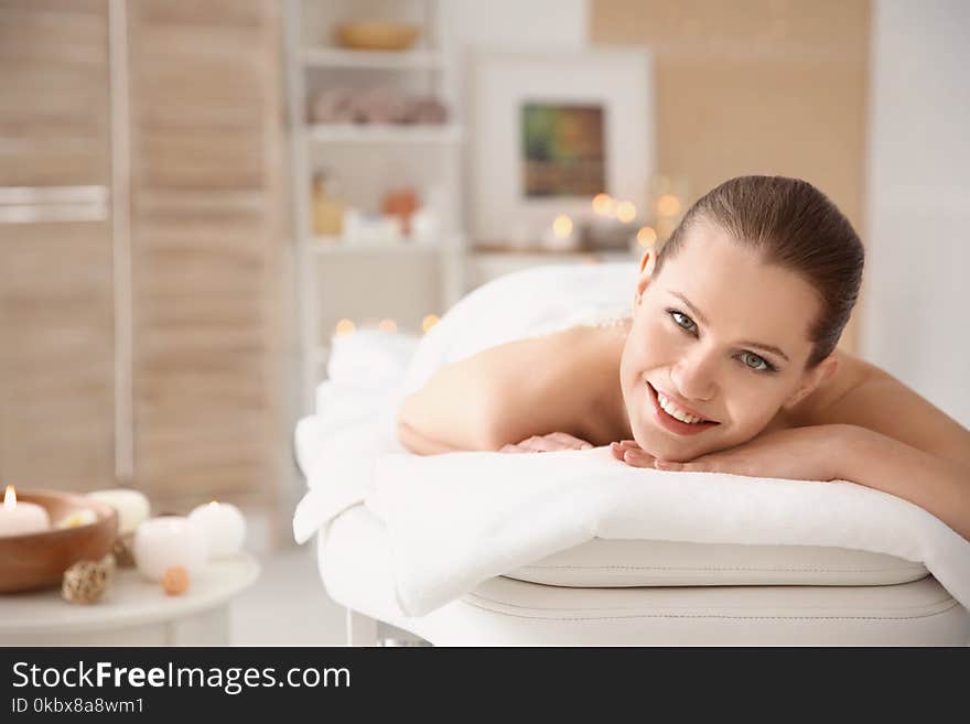 Beautiful young woman having massage with body scrub