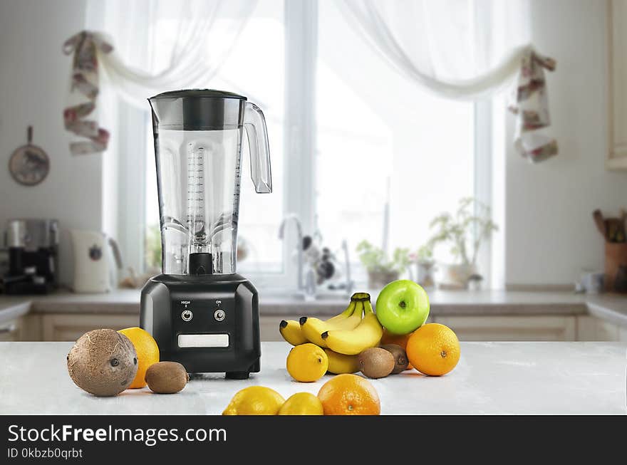 Blender and fruits on kitchen space