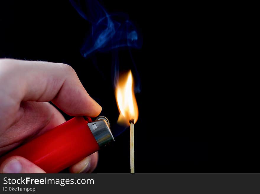 Man Hand With Lighter Start Light On Matchstick On Black