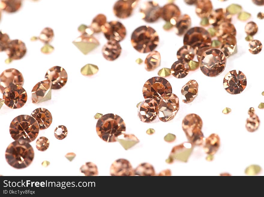 Many scattered rhinestones. On a white background