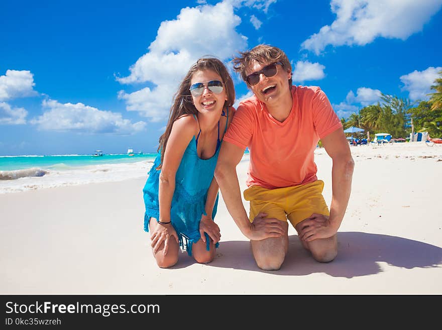 Closeup Of Happy Young Caucasian Couple In Bright Clothes Laughing At Beach