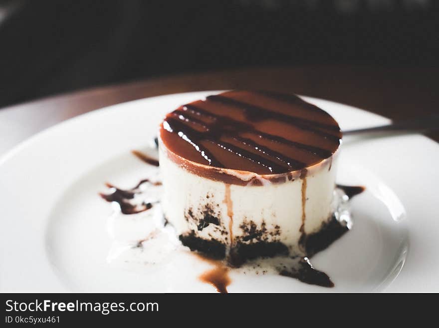 Black, Brown, and White Melted Cake on Round White Ceramic Plate