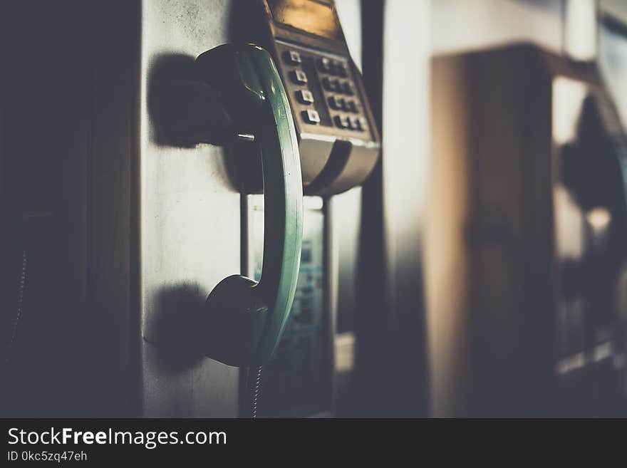 Selective Focus Photo of Green Telephone