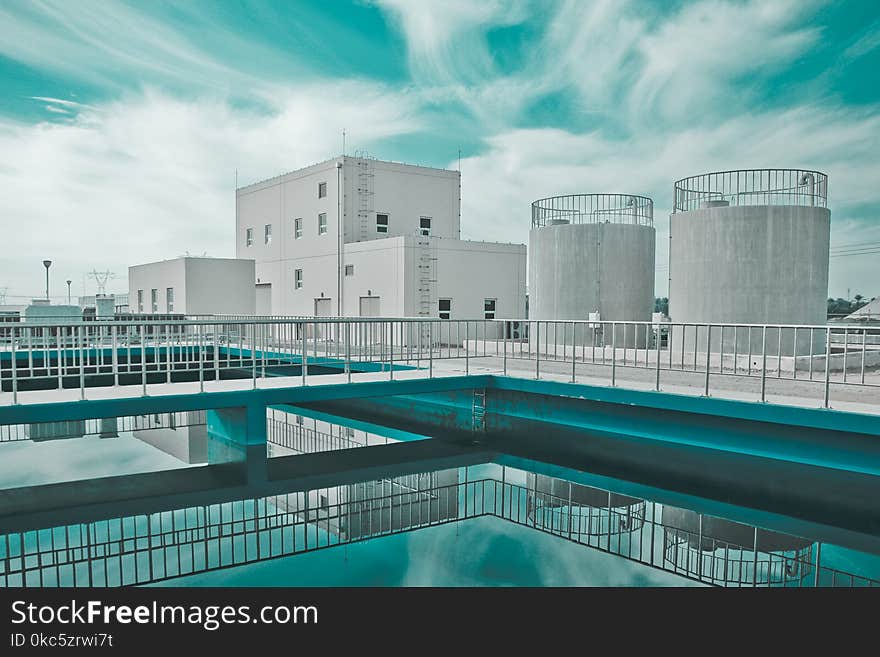 White Building Near Two Gray Water Tanks