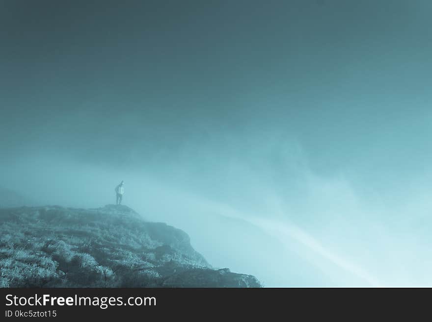 People Standing on Cliff