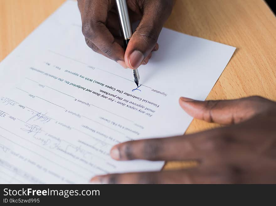 Person Signing Paper