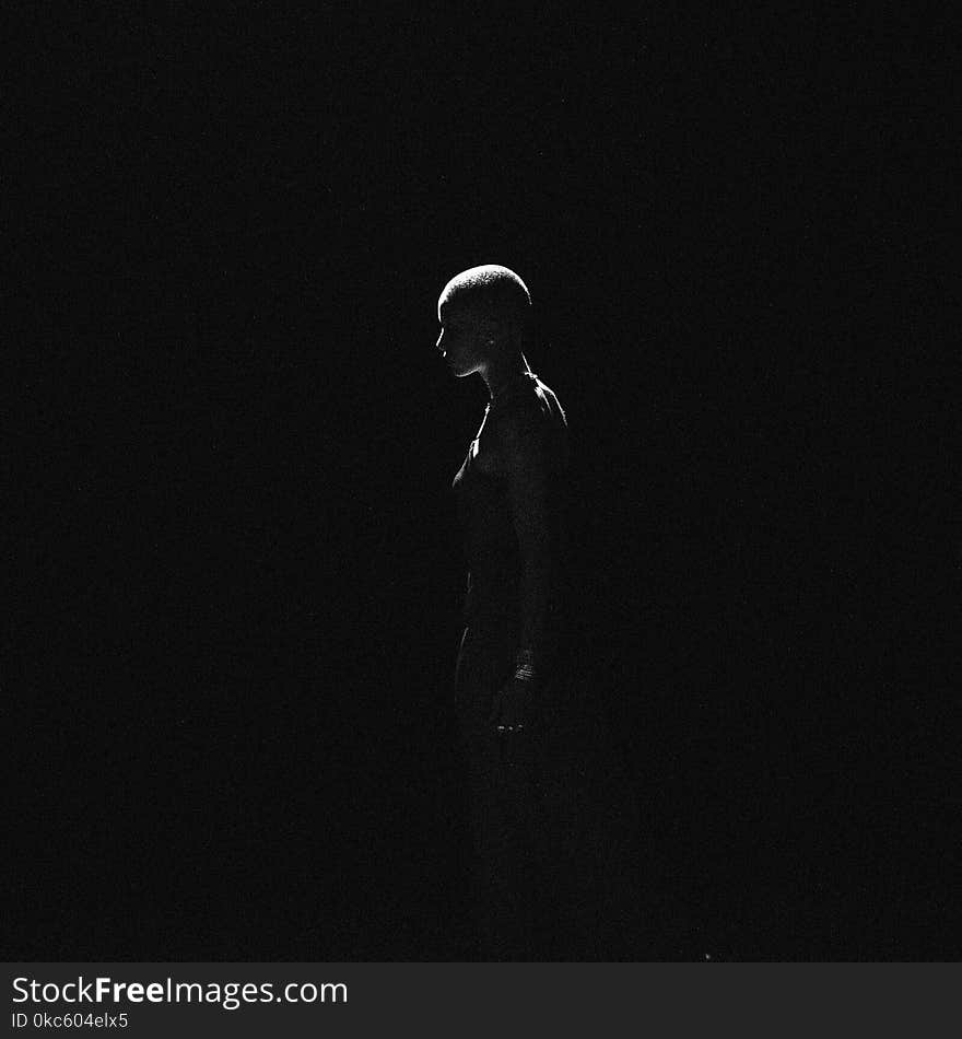 Low Light Photography of Woman on Dark Room