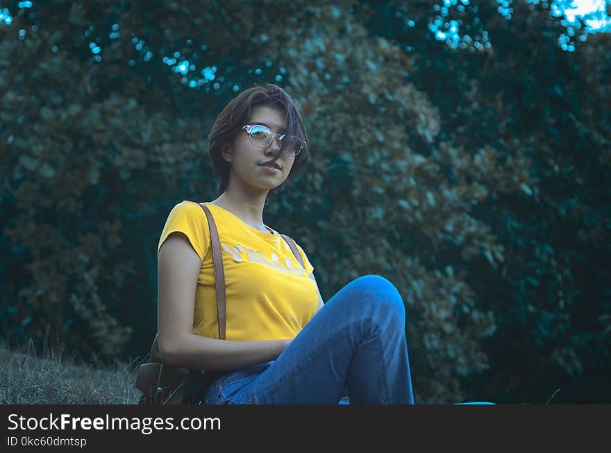 Woman in Yellow Short-sleeved Top and Blue Denim Jeans