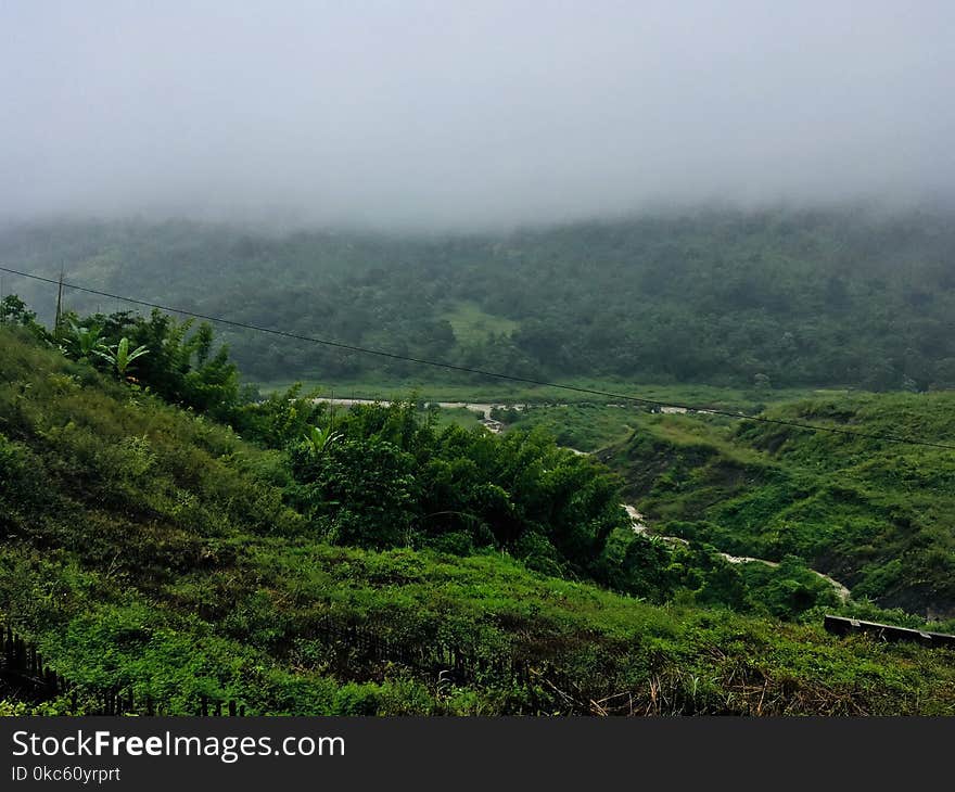 Aerial Photography of Mountain Under White Clouds Foggy Time