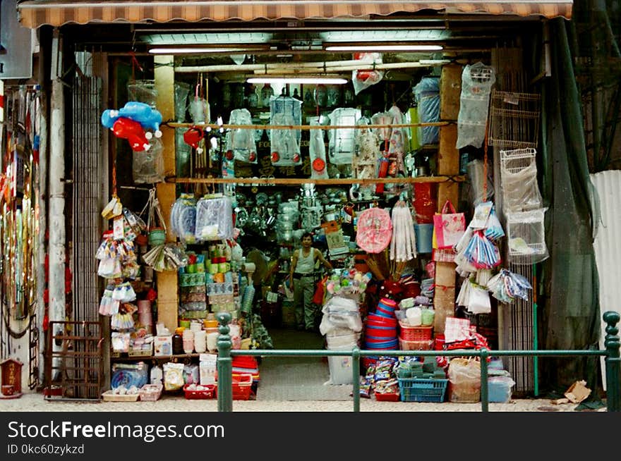 Person Wearing White Tank Top Inside His Store