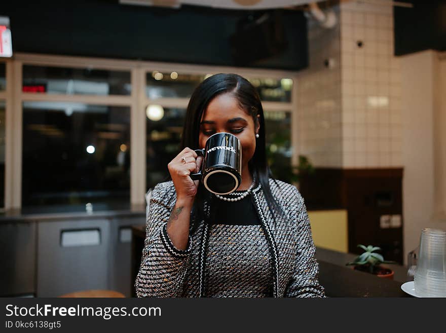 Photo of Woman Holding Black Mug