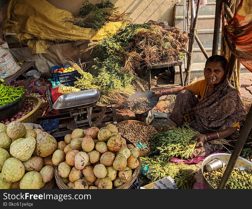 Woman Beside Vegetables On Baskets