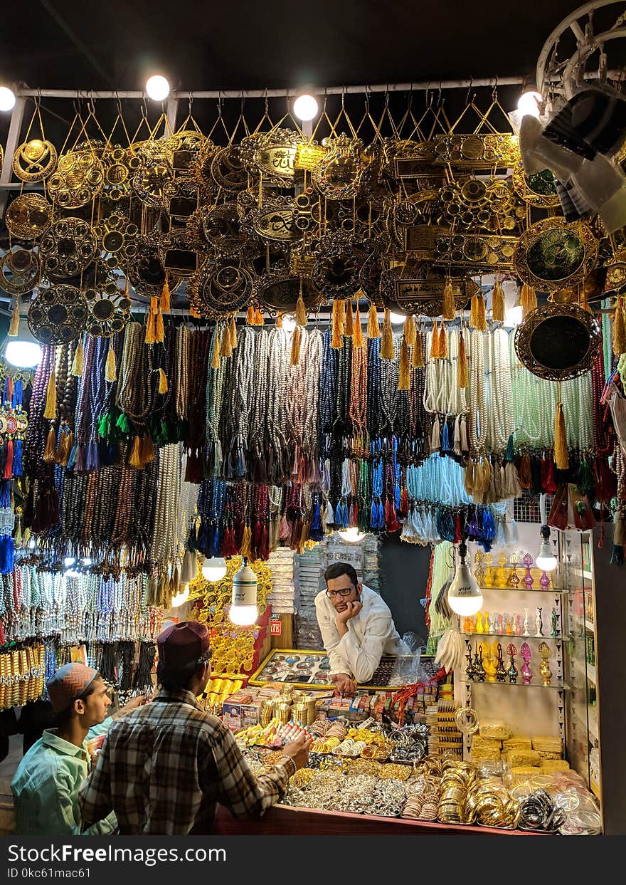 Three Men Surrounded With Jewelries during Nighttime