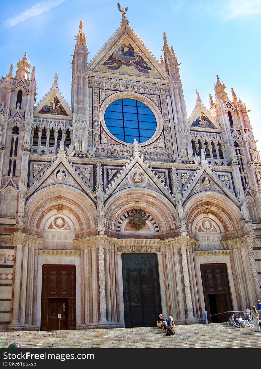 People Sitting On Stairs Of Cathedral