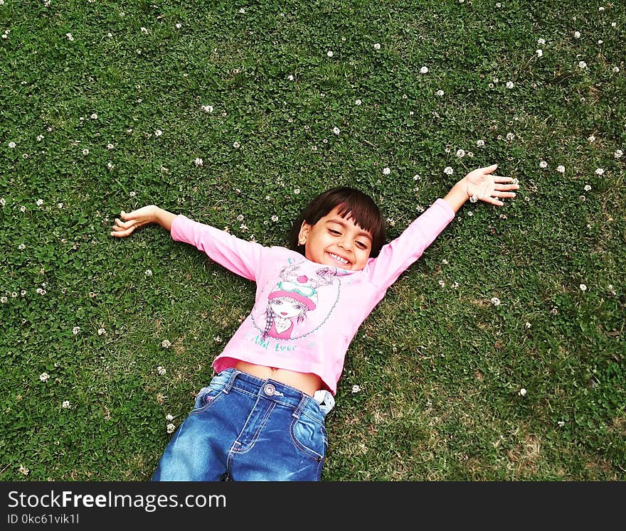 Girl Laying On Green Grass