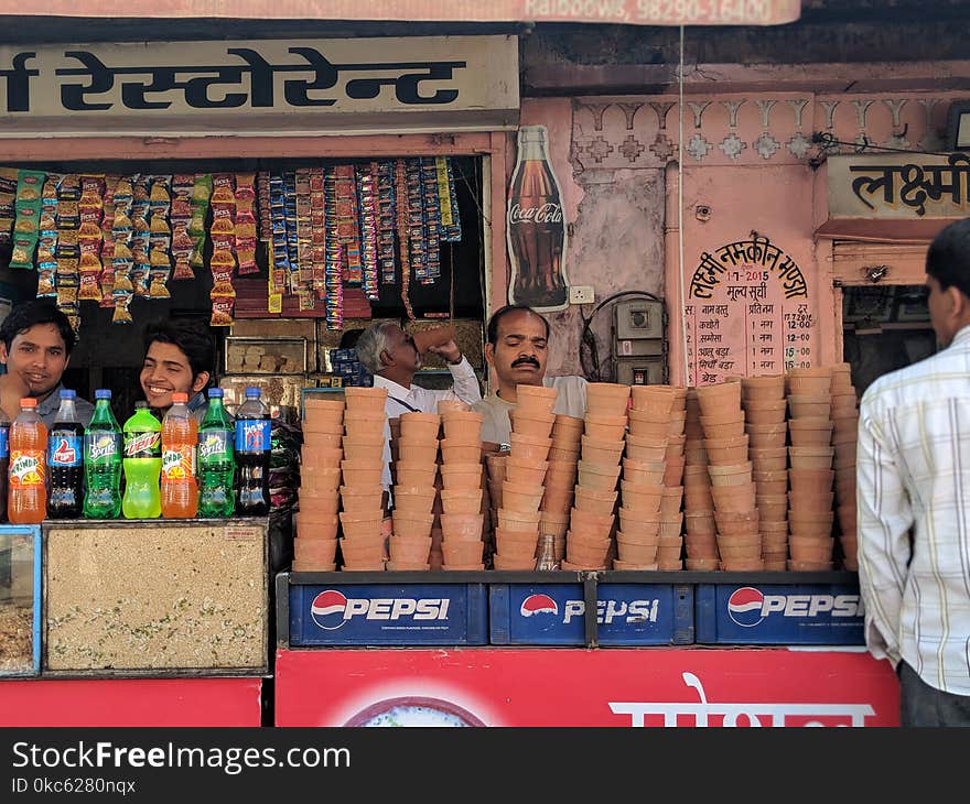 Person Selling Brown Clay Pots