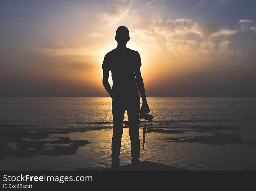 Silhouette Photo of Person Holding Camera