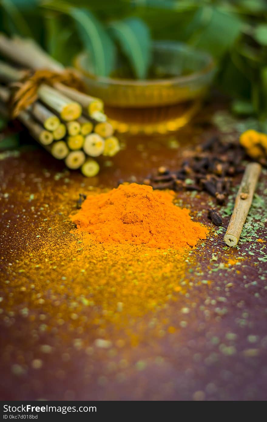 Powder of Indian lilac,Azadirachta indica in a glass plate with its leaves and raw underpowered turmeric.