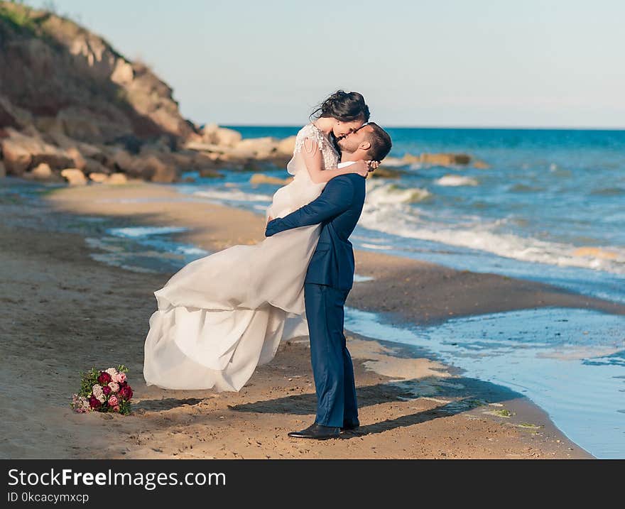 Bride and groom at wedding ceremony near sea outdoors