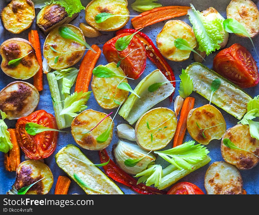 Baked vegetables in large pieces on parchment. Tasty and healthy village food. Baked vegetables in large pieces on parchment. Tasty and healthy village food.
