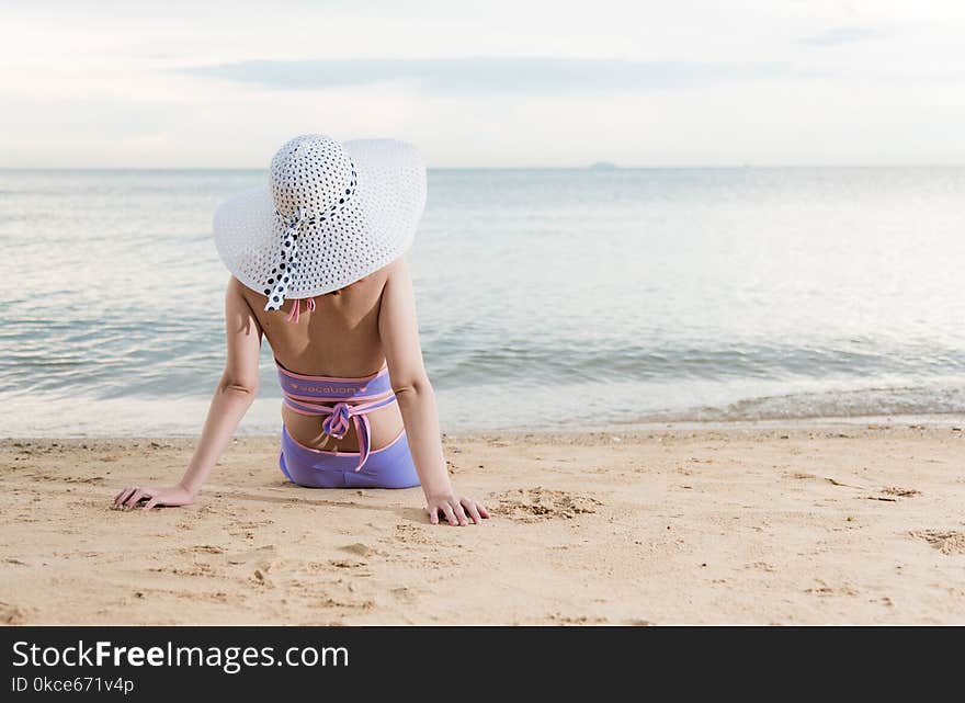 Back woman girl sitting on tropical beach travel relaxation see sea view in vacation summer