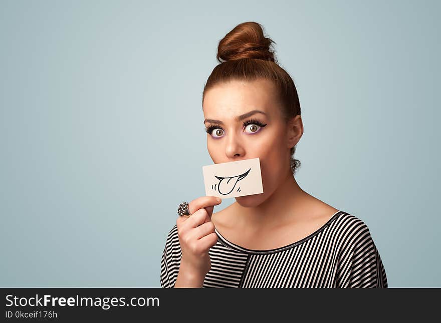 Pretty young girl holding white card with smile drawing