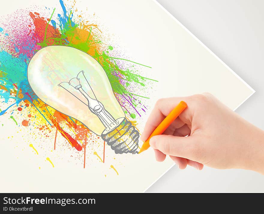 Hand drawing on a plain paper a colorful splatter lightbulb