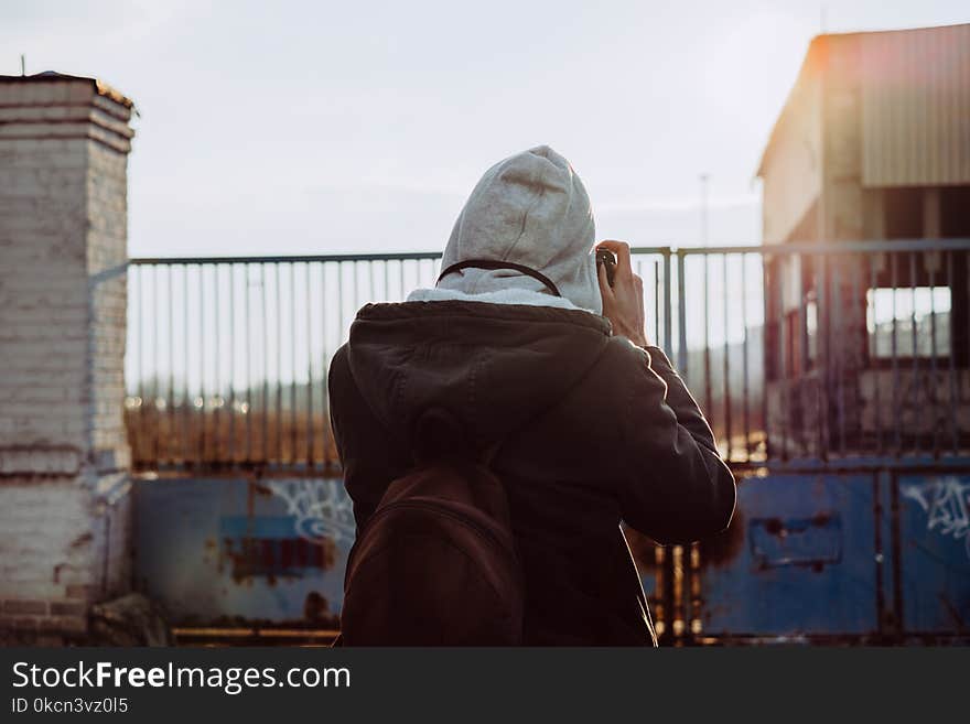 Person Wearing Brown Jacket Taking Photo