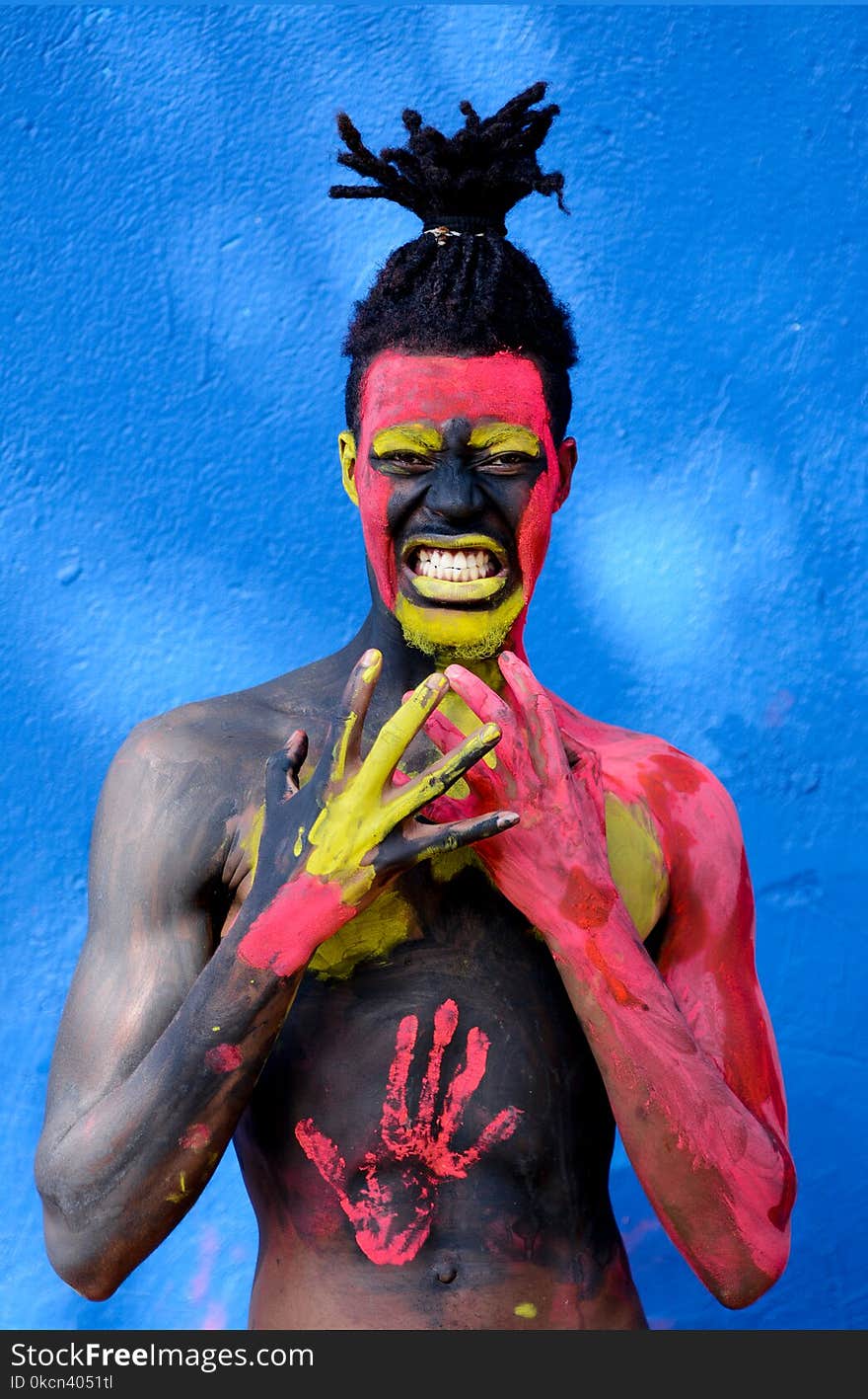 Man Painted With Red and Yellow Paint