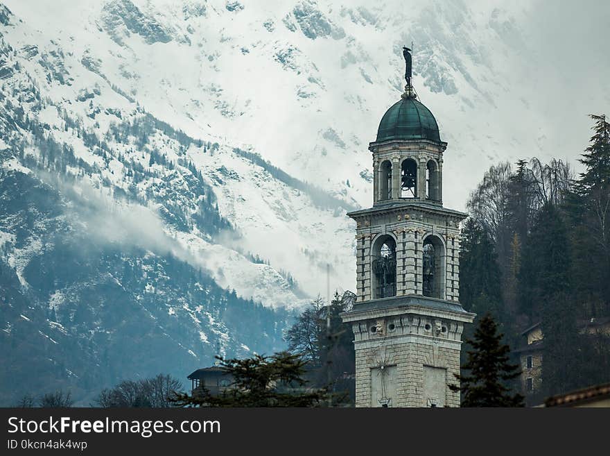 White Concrete Tower Near Mountain