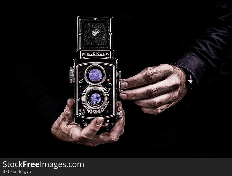 Person Holding Black Twin-lens Reflex Camera