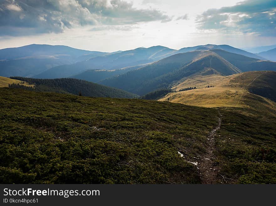 Aerial Photography of Mountain Under Cloudy Sky