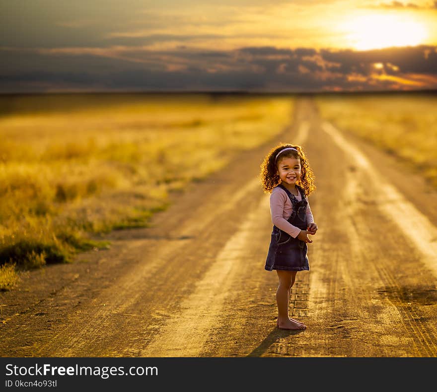 Girl Standing in the Middle of the Road