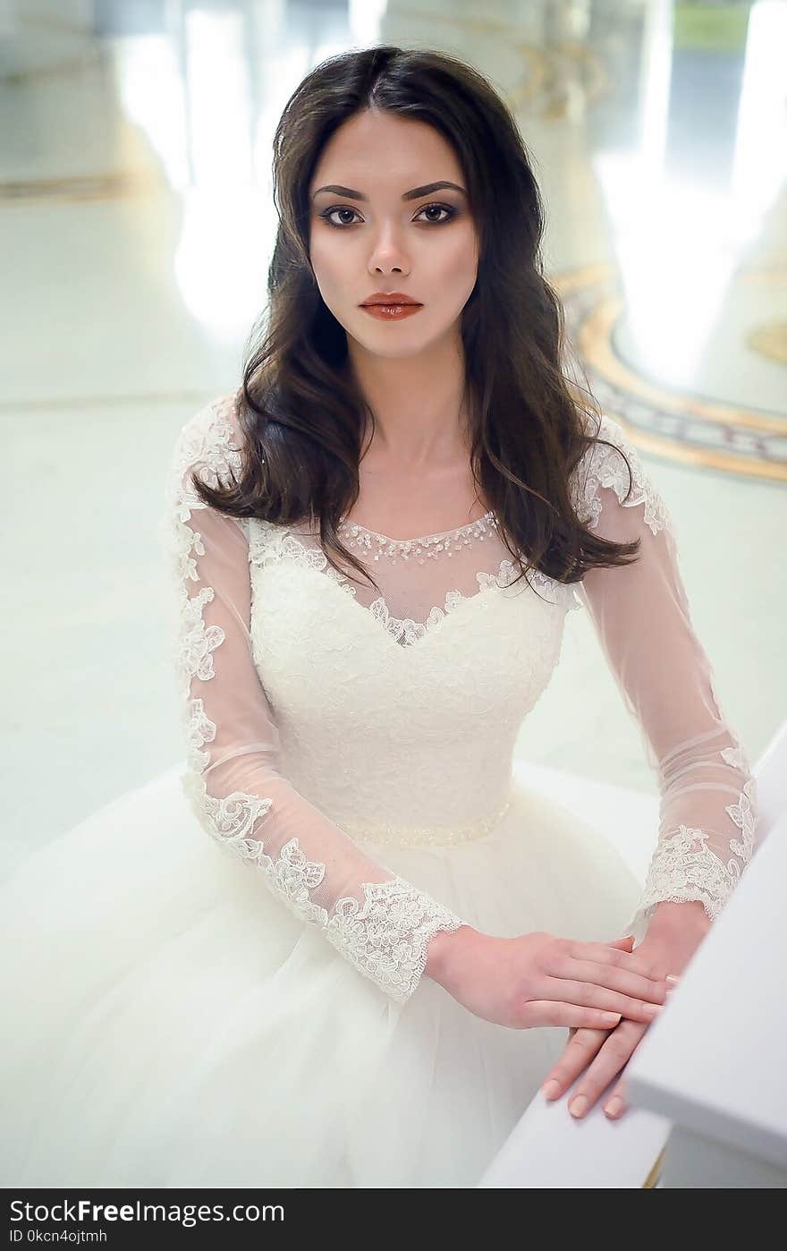 Women in White Long-sleeved Bridal Gown